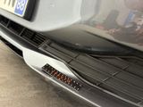 a close up of a car ' s bumper with a number plate on it