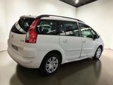 a picture of a white minivan parked in a garage