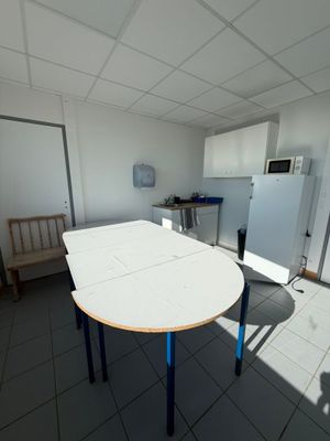 a white table with blue legs in a room