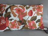 a close up of a pillow with a flower pattern on it