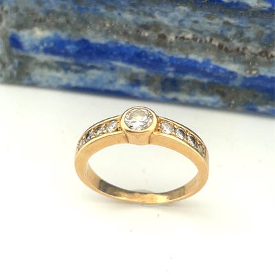 a close up of a gold ring with a diamond on it