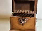 a small wooden box with a lock on top of it