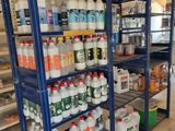 many bottles and containers on the shelves in the store