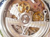 a close up view of a watch with a clock on it