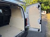 a white van with its doors open on the side of the road