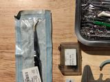 a box of tools sitting on a table next to a pair of scissors