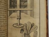 an open book with a drawing of a microscope on it