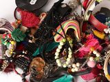 a pile of assorted jewelry on a white surface