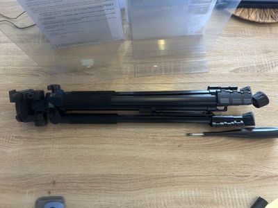 a camera and a tripod sitting on a table