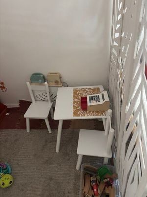 a small table and two chairs in the corner of a room