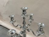 a silver candelab with five candles on it