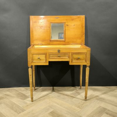 a wooden desk with a mirror on top of it
