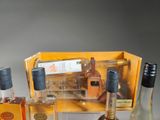 several bottles of alcohol are sitting on a table next to a box