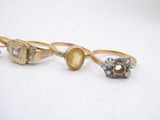 three gold and silver rings with diamonds on them
