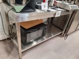 a laptop computer sitting on top of a table in a kitchen