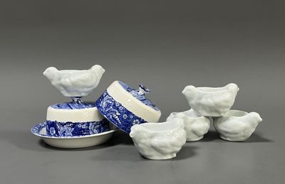 three blue and white porcelain bowls and a bowl with a bird on it