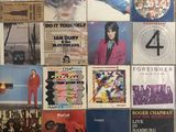the album covers of various albums are displayed on the wall