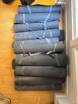 un chat assis sur une pile de couvertures enroulées