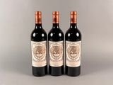 trois bouteilles de vin posées sur une table l'une à côté de l'autre