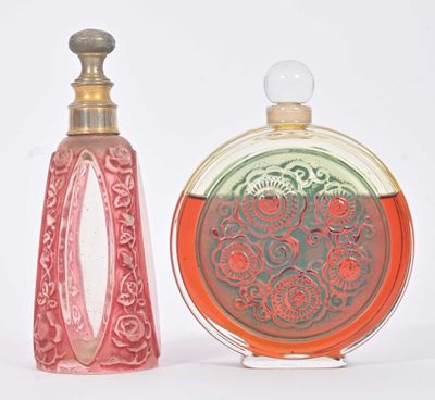 deux flacons de parfum posés l'un à côté de l'autre sur une surface blanche