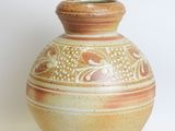 a vase that is sitting on a white surface