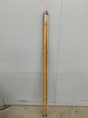 a pair of wooden skis leaning against a wall in a garage