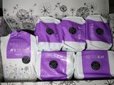 five bags of diapers sitting on top of a couch