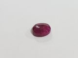 a red ruby gems on a white surface