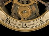 a close up of a clock with gears on it ' s face