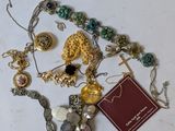 a lot of jewelry that is laying out on the table
