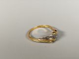an image of a gold and diamond ring on a white surface