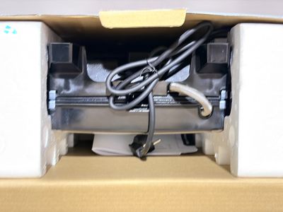 a box that has a printer and a cord in it