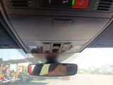 a rear view mirror of a car with a person taking a picture
