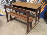 a wooden desk with a bench underneath it