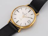a close up of a watch on a white surface