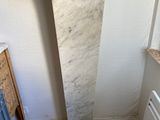 a tall marble pedestal in the corner of a room