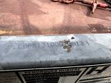 a sign on the hood of an old car