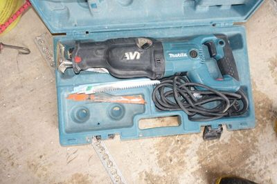 a blue tool box with tools in it on the floor