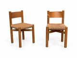 two chairs that are sitting side by side on a white surface