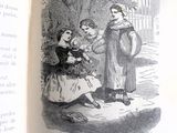 un livre ouvert sur lequel figure l'image d'une femme et de deux enfants
