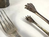 two forks and a spoon on a table