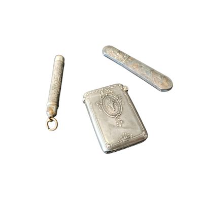 a silver lighter and a lighter case on a white surface