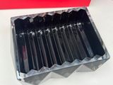 a close up of a metal tray with knives in it