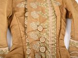 a brown jacket with a green and white design on it