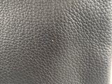 a close up of a black leather purse with a metal clasp