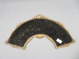 an image of a black and gold mirror on a white surface