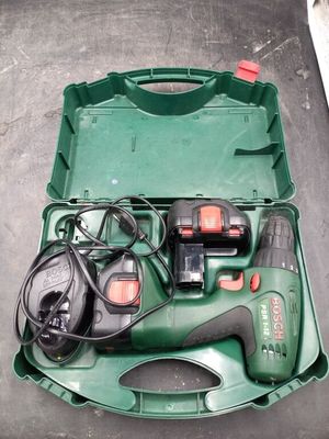 a green box with tools in it sitting on the floor