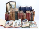 several books are stacked on top of each other on a white surface