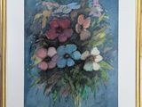painting of a bouquet of flowers in a gold frame on a blue background