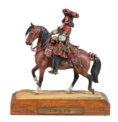 figurine of a man riding a horse on a wooden base